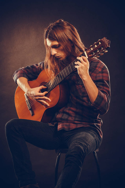 Guitarist is playing the guitar. - Photo, image