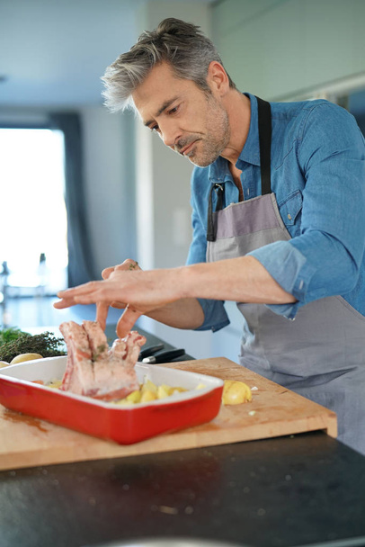  man in kitchen cooking dish for dinner - Photo, image