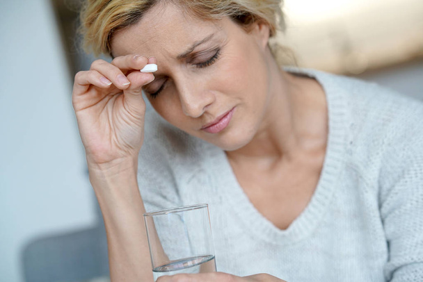 woman at home taking pill  - Photo, Image
