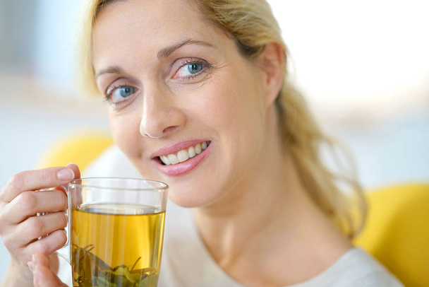 woman drinking plants infusion - Foto, Imagen