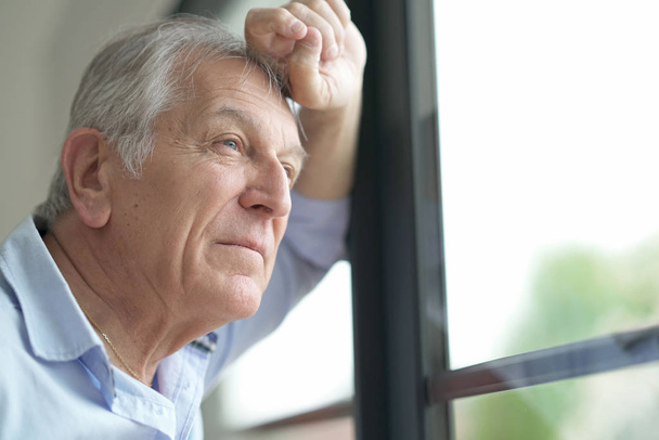  man looking by window - Photo, image