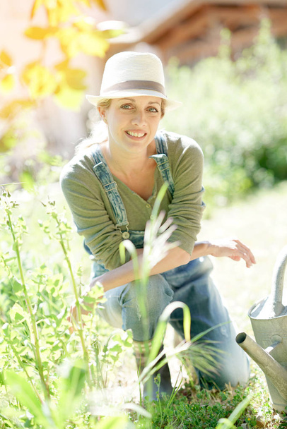 woman with hat gardening on working - Photo, Image