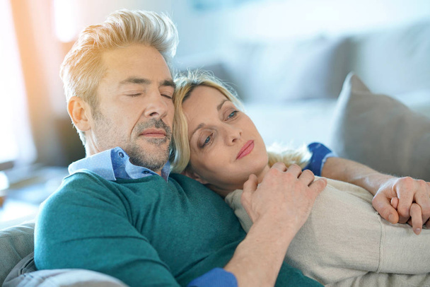 couple relaxing together in sofa - 写真・画像