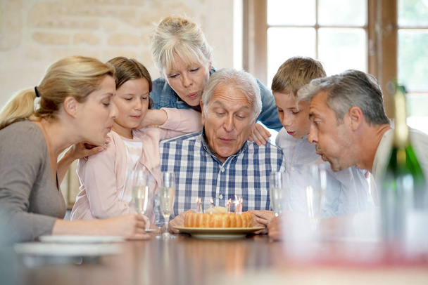 Family celebrating grandfather birthday  - Фото, изображение