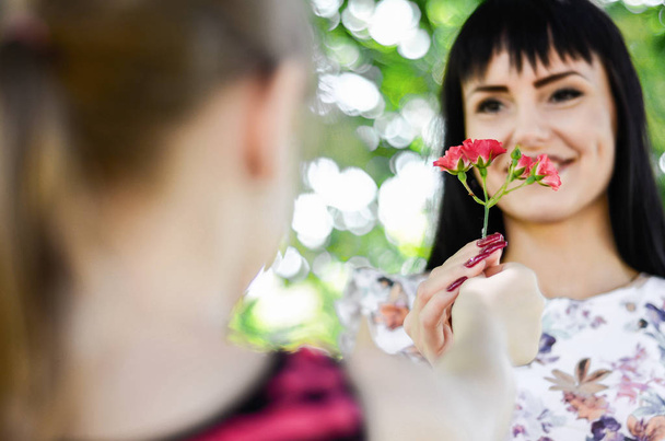 child gives her mom a flower - Photo, image