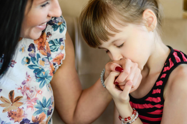 Daughter loves and kissing mom's hands - Photo, Image