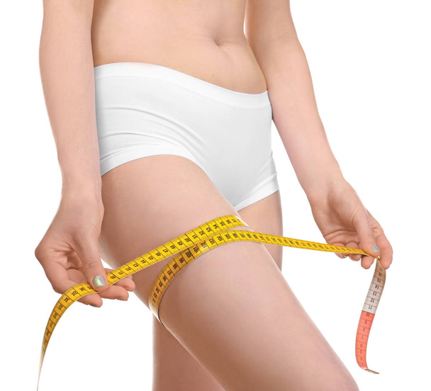 woman in underwear with measuring tape  - Фото, изображение