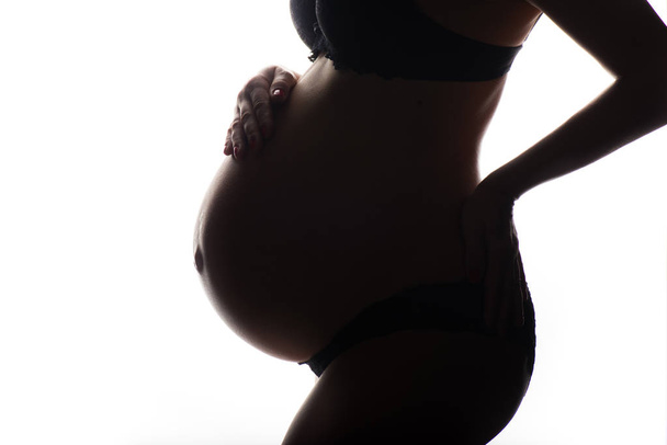 silhouette of Pregnant woman on a white background - Foto, Imagen