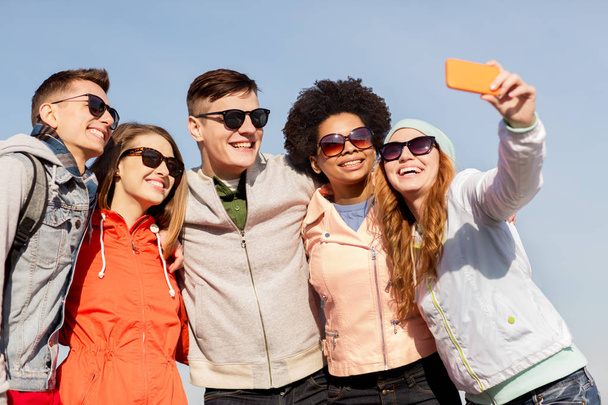 happy friends taking selfie by smartphone outdoors - Valokuva, kuva