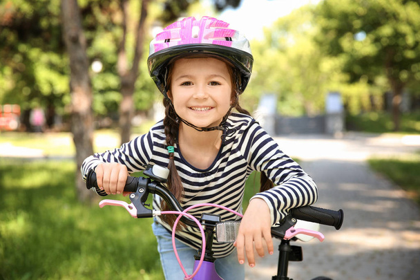 Cute little girl with bicycle - Фото, зображення