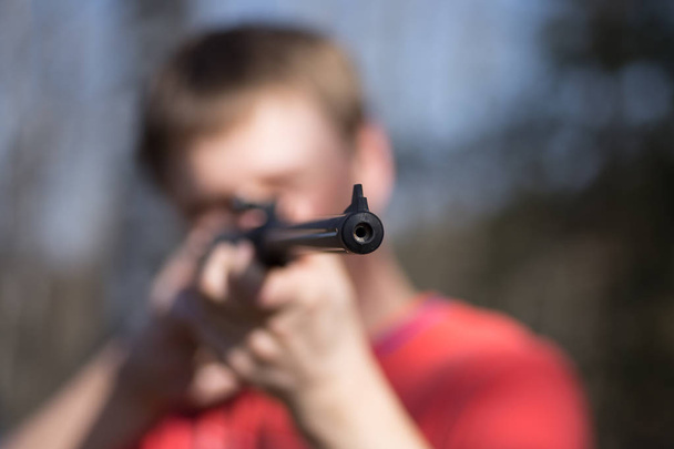man with air gun in forest - Photo, Image