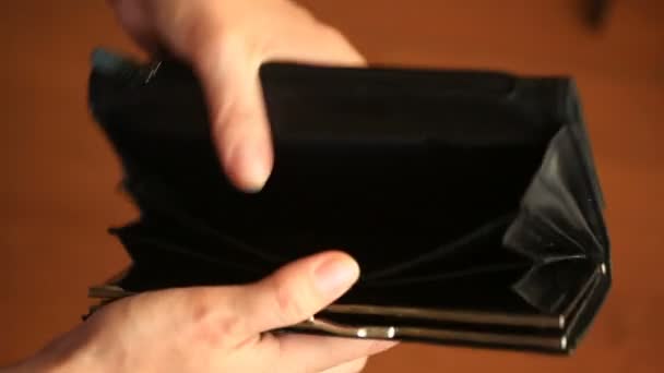 woman shows her empty wallet. Bankruptcy. Bankruptcy - Person holding an empty wallet. businesswoman holding looking into empty wallet. The concept of poverty. - Footage, Video