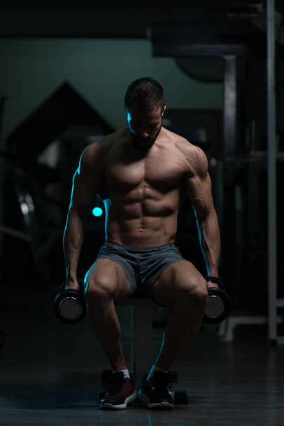 Athlete Exercising Biceps With Dumbbells - Φωτογραφία, εικόνα