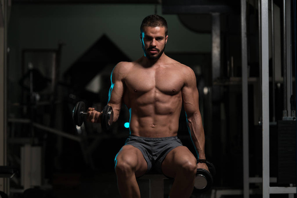 Biceps Exercise With Dumbbells In A Gym - Fotoğraf, Görsel