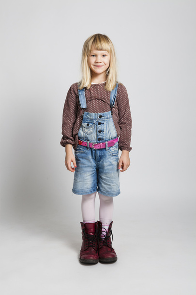 Happy girl wearing adult sized boots - 写真・画像