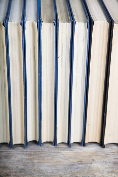 Stack of books on a blue background.  - Foto, Bild