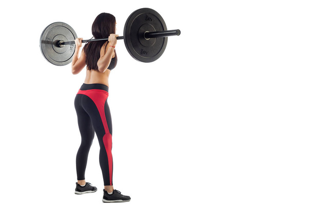 Woman doing squat  with a barbell - Photo, Image