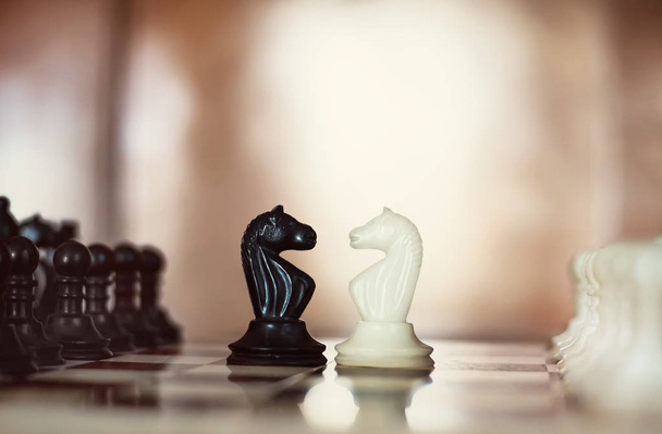 Chess pieces knights facing each other for a standoff - Photo, Image