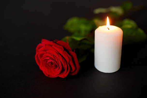 red rose and burning candle over black background - Zdjęcie, obraz