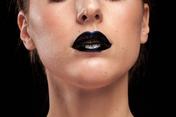 Woman with black lips on black background - Foto, immagini