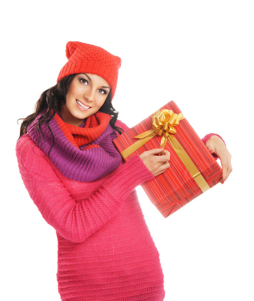 Young and beautiful woman holding a nice Christmas present over white background - Photo, Image