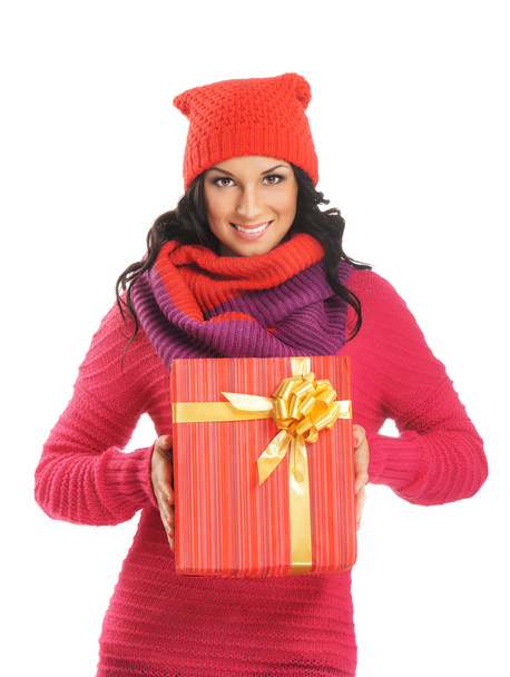 Young and beautiful woman holding a nice Christmas present over white background - Photo, Image