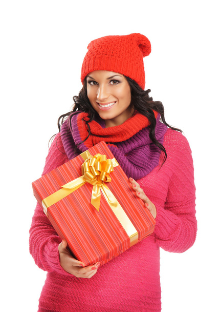 Young and beautiful woman holding a nice Christmas present over white background - Zdjęcie, obraz