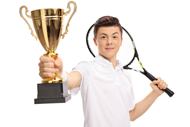 Teenage tennis player holding a golden trophy - Zdjęcie, obraz