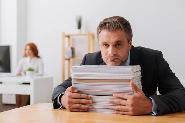 Persistent talented employee receiving a lot of papers working with - Photo, Image