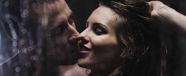 Caucasian couple kissing while having a sensual shower - Photo, Image