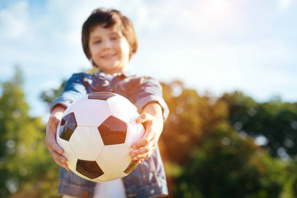 Motivated bright child holding a ball - Фото, зображення