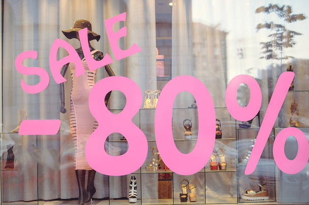 Shop window with women's clothing sale 80% - 写真・画像