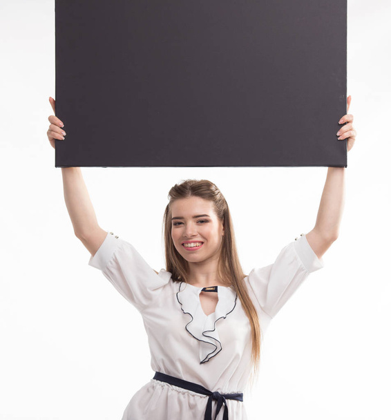 Young happy woman showing presentation, pointing on placard over - Fotó, kép