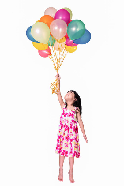Asian little Chinese girl flying with colorful balloons - Valokuva, kuva