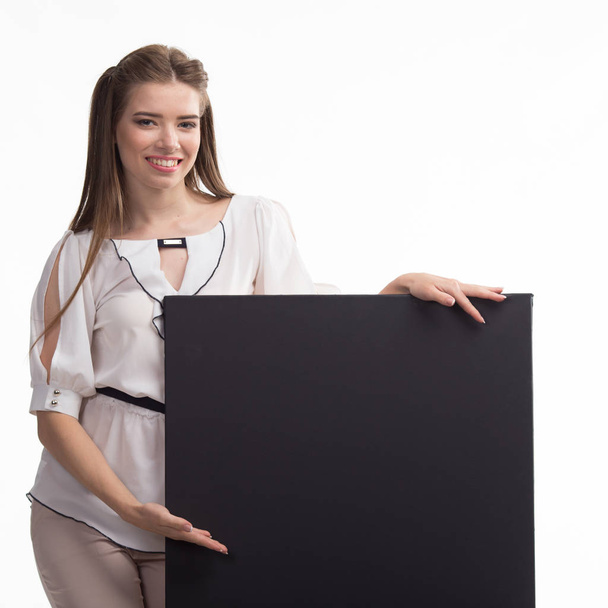 Young happy woman showing presentation, pointing on placard over - Fotografie, Obrázek