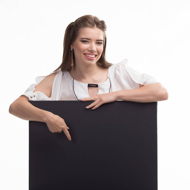 Young happy woman showing presentation, pointing on placard over - Foto, Bild