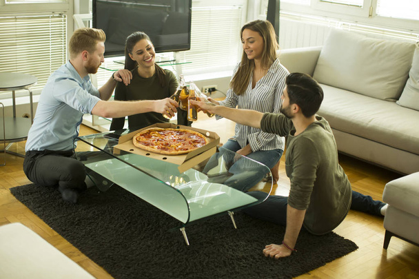 Young people eating pizza and drinking cider - Photo, image