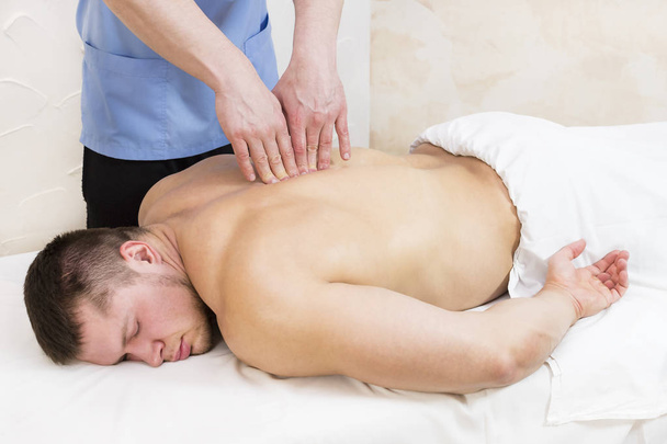 Man doing sports massage - Fotó, kép