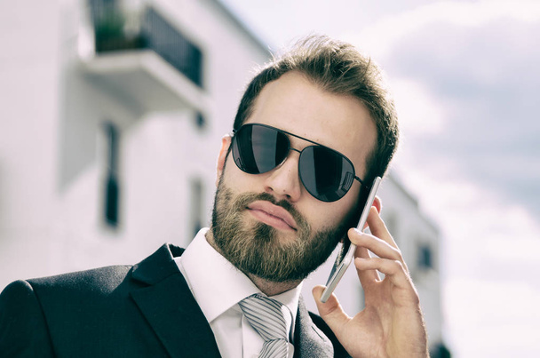 Handsome businessman talking on phone city outdoor - Fotoğraf, Görsel