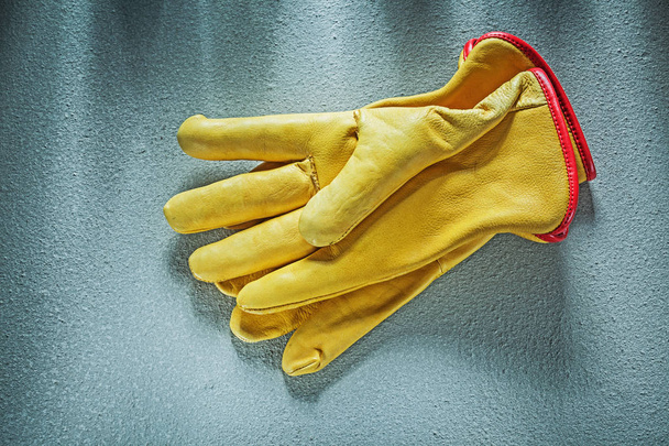 Leather safety gloves on concrete background construction concep - Фото, изображение