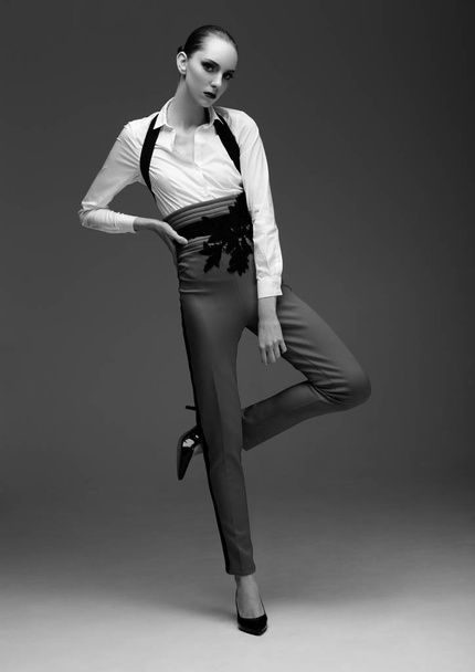 Fashion model wearing long pants and white shirt - Foto, Imagem