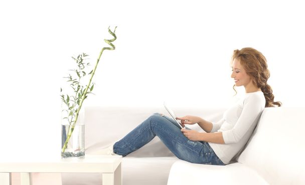 Young attractive woman with a tablet in modern interior - Foto, Imagen