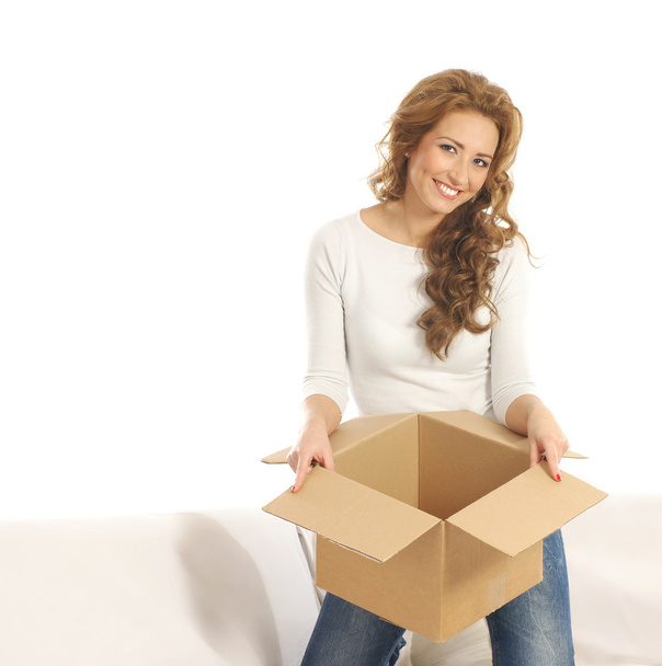 Young attractive woman with a parcel in modern interior - Foto, imagen