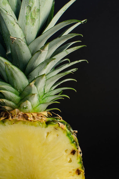 sliced pineapple fruit close up, black background - Фото, изображение