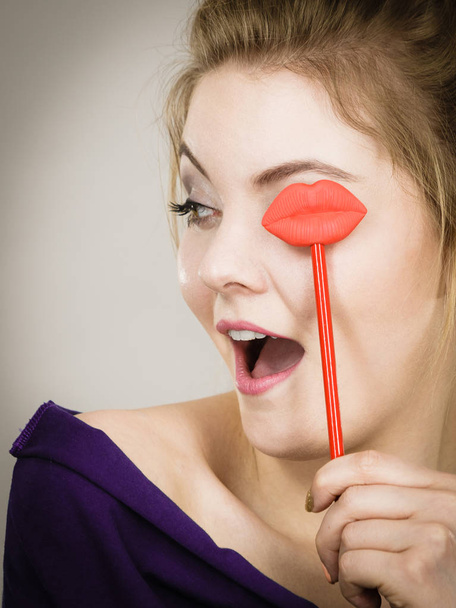 Happy woman holding lips on stick - Fotografie, Obrázek