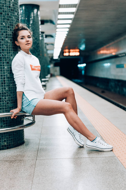 Beautiful young girl posing on metro station - Photo, Image