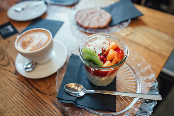 Cappuccino with spoon in cup and dessert - Foto, Imagen