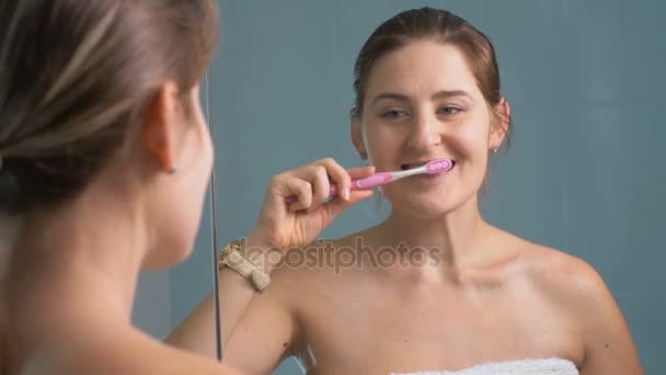 4K крупным планом, где молодая женщина чистит зубы утром
 - Кадры, видео