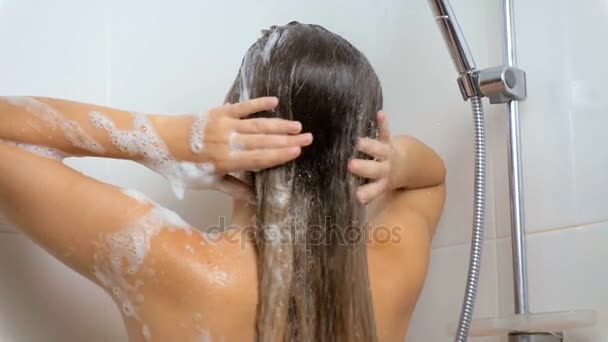 Seksowna brunetka kobieta mycia włosów pod prysznicem - Materiał filmowy, wideo