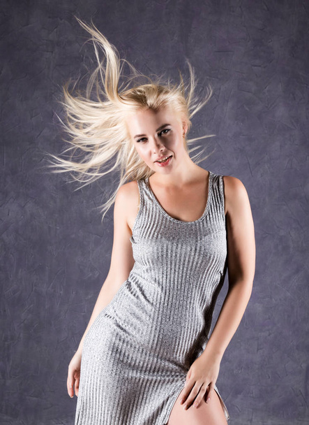blonde woman with hair in the wind. sexy girl with flying hair. beauty concept - Foto, imagen